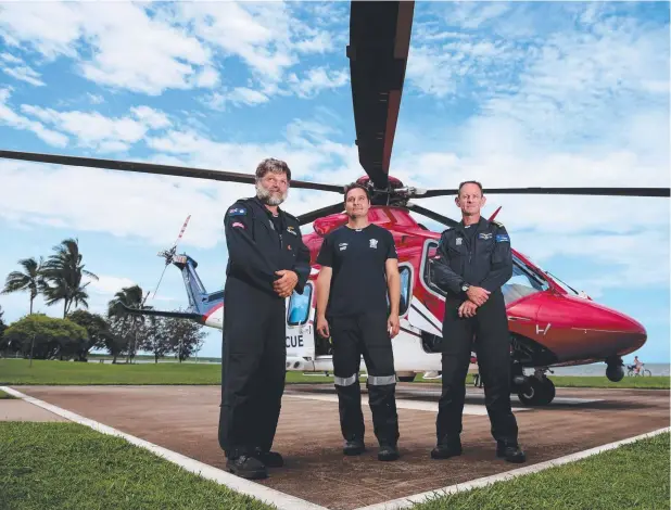  ?? Picture: STEWART McLEAN ?? HARD WORK: Rescue crew members air crew officer Dany Portefaix, rescue crewman Stuart Wark and pilot Greg Kempton with the Cairns based rescue helicopter which was kept busy all Christmas weekend.