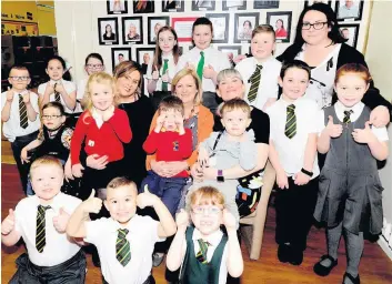  ??  ?? Bon voyage Mrs Cruickshan­k (sitting centre) with the pupils and new head Mary-Ann Preston (sitting right)