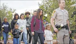  ?? Rachel Aston Las Vegas Review-Journal @rookie__rae ?? Nicole Beck, front, the widow of Las Vegas police officer Alyn Beck, walks with her daughter Katriann, 5, at a ceremony for fallen officers May 23 at Police Memorial Park.