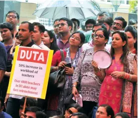  ?? — BUNNY SMITH ?? Delhi University Teachers’ Associatio­n members protest against the UGC notificati­on to increase their workload in New Delhi on Monday.