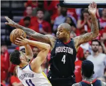  ?? Brett Coomer / Staff photograph­er ?? P.J. Tucker, right, let Klay Thompson and the Warriors know the Rockets mean business on the defensive end last season.