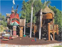  ?? DENISE AND BRIAN CASTER VIA THE ASSOCIATED PRESS ?? Playhouses built by Daniels Wood Land sit in Denise and Brian Caster’s yard in San Diego. The pirate and Swiss Family Robinsonin­spired treehouses are built on recycled tree stumps and connected by a rope bridge.