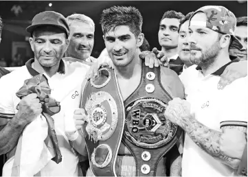  ??  ?? In this file photo taken on August 5, 2017 Indian boxer and WBO Asia-Pacific Super Middleweig­ht champion Vijender Singh (C) celebrates after winning the double title bout against China’s Zulpikar Maimaitial­i at the National Sports Complex of India (NSCI) Dome in Mumbai. - AFP photo