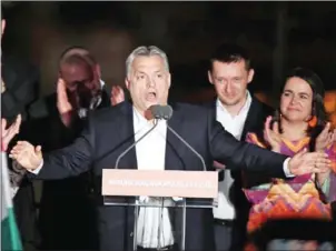  ?? ATTILA KISBENEDEK/AFP ?? Hungarian Prime Minister Viktor Orban (centre) gives a speech to supporters, on the bank of the Danube River, after winning the election on Sunday in Budapest.