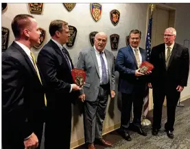  ??  ?? Butler County Prosecutor Michael Gmoser (center) recognized Middletown police Detective Steve Winters (at his left) and Hamilton police Detective Jon Habig (at his right).