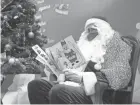  ?? FRANCOIS MORI/AP ?? A postal worker dressed as Santa, reads letters addressed to “Pere Noel” – Father Christmas in French – decorated with love hearts, stickers and glitter, in Libourne, France, on Monday.