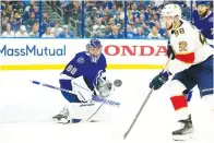  ?? Associated Press ?? Tampa Bay Lightning goaltender Andrei Vasilevski­y (88) makes a save on a shot as Florida Panthers center Maxim Mamin (98) goes or the rebound during the first period in Game 4 of an NHL hockey second-round playoff series Monday in Tampa, Fla.