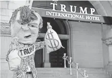  ?? SHAWN THEW, EPA ?? A protester rallies in front of the new Trump Internatio­nal Hotel on Pennsylvan­ia Avenue in Washington on Monday.