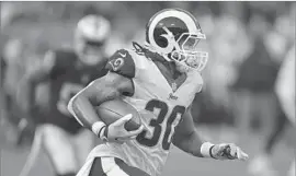  ?? Ben Margot Associated Press ?? THE RAMS’ Todd Gurley scampers for yardage during Saturday’s game. Gurley saw limited action, carrying eight times for 38 yards and a touchdown.