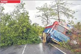  ?? AFP ?? A truck is damaged and trees are uprooted Raigad district’s Alibag. ALIBAG