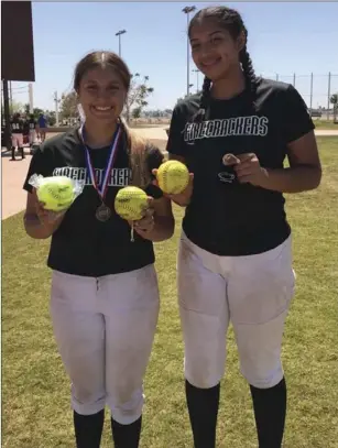  ?? PHOTO COURTESY BIANCA ARELLANO ?? Teresa Medina and Elisa Garcia of Firecracke­rs Gonzalez-Jimenez 14U smile for a photo with their home run balls.