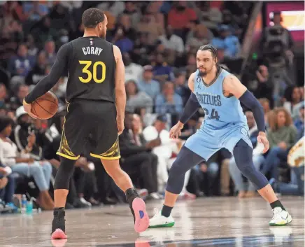 ?? STU BOYD II/THE COMMERCIAL APPEAL ?? Memphis Grizzlies forward Dillon Brooks (24) defends against the Golden State Warriors guard Stephen Curry (30) during a game at the Fedex Forum on Saturday in Memphis.