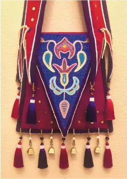  ??  ?? RIGHT: “Chata Anumpa in My Accent,” antique and contempora­ry seed beads, wool fabric, silk dupioni, silk tassels, brass sequins, brass beads, handmade glass beads, Swarovski crystals, brass bells, Chinese crystal, brain-tanned buckskin.