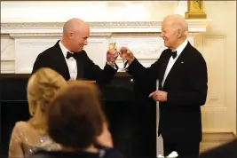  ?? STEPHANIE SCARBROUGH — THE ASSOCIATED PRESS ?? Utah Gov. Spencer Cox, left, and President Joe Biden toast before Biden speaks to members of the National Governors Associatio­n during an event in the State Dining Room of the White House in Washington, Saturday.