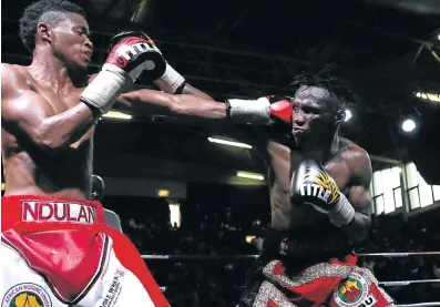  ?? Picture: MARK ANDREWS ?? TOUGH BATTLE: Ayanda Ndulani, left, and Xolisa Magusha exchange punches during their mini-flyweight bout at the Orient Theatre on Sunday.