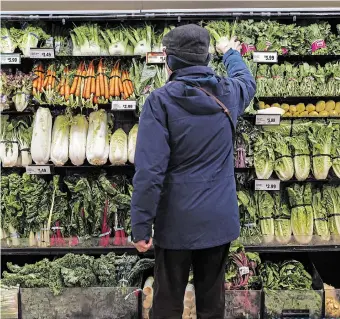  ?? COLE BURSTON CANADIAN PRESS FILE PHOTO ?? Some estimates suggest that about 40 per cent of fruits and vegetables never even leave farms. Much of it gets rejected by wholesaler­s and retailers based on irregulari­ties in weight, size or shape.
