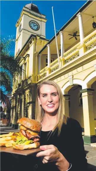  ?? WHEELY GOOD: The Brewery sales and marketing manager Emily Young with a double cheese American burger which can be delivered to your home by Uber Eats. Picture: EVAN MORGAN ??