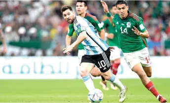  ?? — AFP photo ?? Messi and Mexico’s midfielder Erick Gutierrez (right) fight for the ball during their Group C match at the Lusail Stadium, north of Doha.