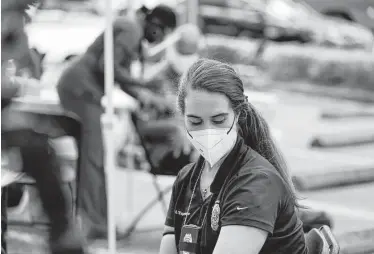  ?? Martha Asencio-Rhine / Associated Press ?? Detective Stefani L’Esperance waits at a vaccinatio­n tent after getting her second dose of the Pfizer vaccine on Tuesday in St. Petersburg, Fla. A study found waning levels of antibodies with Pfizer’s vaccine.