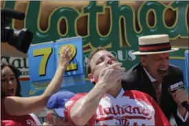  ?? BEBETO MATTHEWS — ASSOCIATED PRESS ?? Joey Chestnut eats two hot dogs at a time during the Nathan’s Annual Famous Internatio­nal Hot Dog Eating Contest, Tuesday July 4, 2017, in New York. Chestnut won, marking his 10th victory in the event.