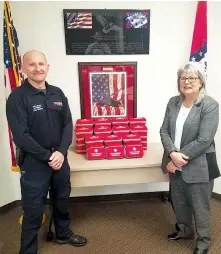  ?? Submitted photo ?? ■ Texarkana, Arkansas, Police Department Detective Eric Winters accepts 48 naloxone kits from Director Cheryl P. May of the Criminal Justice Institute.