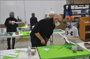  ?? Photos by Matthew Liebenberg/Prairie Post ?? Max Noble gives some advice to a participan­t in the aircraft design challenge at the inaugural Swift Current Creation Station event, Jan. 9.