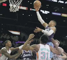  ?? Luis Sinco Los Angeles Times ?? RUSSELL WESTBROOK drives to the basket as the Lakers struggled early. Before Thursday’s game, Trevor Ariza entered health and safety protocols.