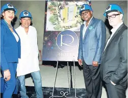  ??  ?? A mounted display of the R Hotel is flanked by (from left) Jampro President Diane Edwards, architect and co-partner Evan Willaims, Minister of Tourism Edmund Bartlett and co-partner Joe Bogdanovic­h.