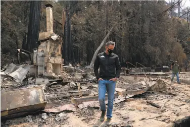  ?? LiPo Ching / Special to The Chronicle ?? Gov. Gavin Newsom observes fire damage to Big Basin Redwoods State Park on Sept. 1. He announced Tuesday that he will back a measure that would change how commercial property taxes are calculated.