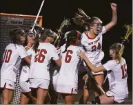  ?? Dave Stewart / Hearst Connecticu­t Media ?? The New Canaan girls lacrosse team celebrates after defeating Darien 10-8 for the FCIAC championsh­ip on Wednesday in Norwalk.