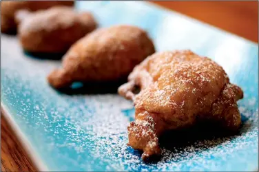  ?? Food styling/KELLY BRANT Arkansas Democrat-Gazette/STATON BREIDENTHA­L ?? Calas, biegnetlik­e fritters that include rice, are served with a light dusting of confection­ers’ sugar.