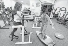  ?? Melissa Phillip / Houston Chronicle ?? Third-graders Andrea Dominguez, left, and Shawn Socop, both 8 years old, are among the students getting the benefits of active-based learning at Best Elementary.