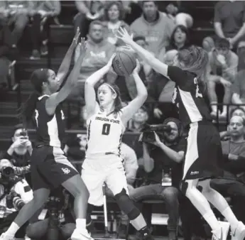  ??  ?? Oregon State’s Mikayla Pivec is double-teamed by Long Beach State’s Chanterria Jackson, left, and Madison Montgomery on Friday in Corvallis, Ore. Timothy J. Gonzalez, The Associated Press