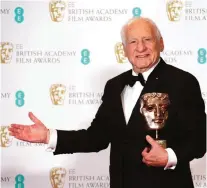  ??  ?? Mel Brooks poses for photograph­ers with his BAFTA Fellowship award.