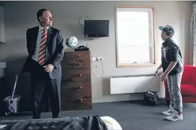  ??  ?? ‘Pretty cool’: Prime Minister John Key flips the rugby ball behind his back to an impressed James Aberdein-tapuai, 10, at Ronald Mcdonald House in Christchur­ch yesterday.