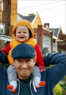  ?? Courtesy of Max Risch ?? CMU economist Max Risch out on a walk with his son, Otis.