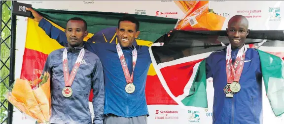  ?? PATRICK DOYLE ?? Yemane Tsegay, centre, is flanked by second-place finisher John Korir, right, and third-place finisher Adugna Takele Sunday as the men’s Scotiabank Ottawa Marathon winner.