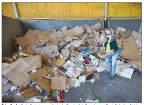  ?? (NWA Democrat-Gazette/Andy Shupe) ?? Brian Pugh, Waste Reduction coordinato­r for Fayettevil­le’s Recycling and Trash Collection Division, removes a contaminan­t Friday from a pile of corrugated cardboard at the division’s facility. Recycling collection during suspension of the curbside program was about 79% of what it was from March to June last year. The city’s curbside service resumes Monday. Go to nwaonline.com/200621Dail­y/ for today’s photo gallery.