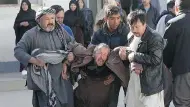  ?? RAHMAT GUL / THE ASSOCIATED PRESS ?? A distraught man is carried following a suicide attack on a Shiite Muslim cultural centre in Kabul Thursday.