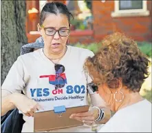  ??  ?? Disability advocate Erin Taylor and other volunteers prepare this summer to collect signatures for the petition to put Medicaid expansion to a vote of the people during a kickoff drive for Yes on 802 in Oklahoma City. [NATE BILLINGS/ THE OKLAHOMAN]