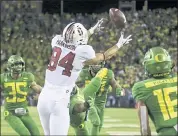  ?? CHRIS PIETSCH — THE ASSOCIATED PRESS ?? Stanford’s Colby Parkinson, center, pulls down a touchdown pass in overtime to beat Oregon on Saturday.