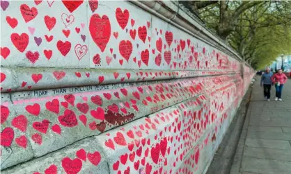  ?? Hospital. Photograph: Guy Bell/REX/Shuttersto­ck ?? ‘The NHS forecasts that there will be 230,000 new cases of PTSD in England as a result of Covid-19.’ The national Covid Memorial Wall outside St Thomas'