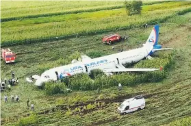  ?? Associated Press ?? A Ural Airlines plane landed in a cornfield outside Moscow after it collided with a flock of gulls after takeoff, causing both engines to malfunctio­n.