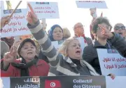  ?? AP ?? People demonstrat­e outside the Tunisian parliament, in Tunis, on Sunday.