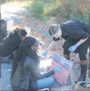  ??  ?? Henry E. Lackey art teacher Vicki Marckel, right, provides shadowing tips to senior Chicchi Igwe while she paints a picture of Mallows Bay as part of a cooperativ­e art project with Charles County government and NOAA.