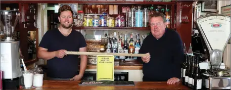  ??  ?? Glenn and Martin keeping their distance as Peggy Moore’s pub reopened on Monday.