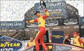  ?? Matt Kelley Associated Press ?? JOEY LOGANO celebrates in victory lane after his next-to-last-lap move to steal the NASCAR Cup race at Darlington, snapping a streak of 40 races without a win.