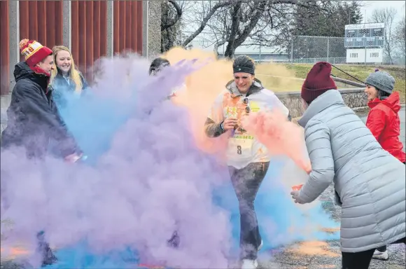  ?? KIRK STARRATT ?? Runners were covered head to toe in bright colours as they crossed the finish line at the second annual A Run to Dye For in Wolfville April 8. To find up why they ran, and to see more photos, turn to page A6.