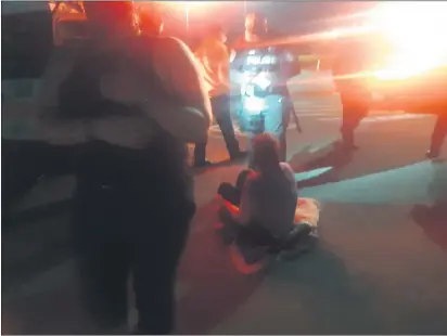  ?? SONIA WARAICH — THE TIMES-STANDARD ?? A protester gives a report to the Eureka Police Department about being struck by a truck while blockading 5th Street in Eureka with dozens of other protesters on Thursday night. The protest was sparked by a grand jury refusing to indict members of the Louisville Metro Police Department for the fatal shooting of Breonna Taylor, a 26-year-old Black healthcare worker, in March.