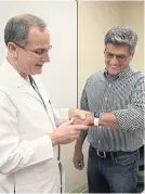  ??  ?? Dr Milani discusses use of the Apple Watch with a patient.